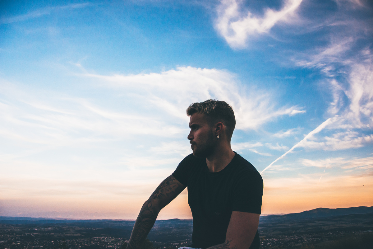 Man Sitting Under the Blue Skies